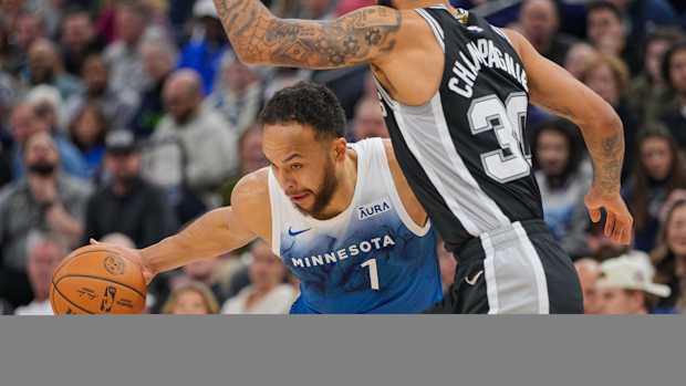 Minnesota Timberwolves forward Kyle Anderson (1) dribbles against the San Antonio Spurs forward Julian Champagnie (30) in the first quarter at Target Center in Minneapolis on Feb. 27, 2024.